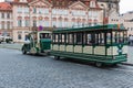 Empty green tourist sightseeing trackless train on the Prague Old Town Square